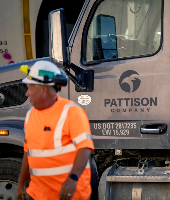 Pattison Sand CDL Driver tightening chain on truck